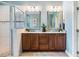 Bright bathroom with double sink vanity, granite countertops, and a tiled shower at 610 Bennett Mountain, Chapel Hill, NC 27516