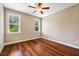 This cozy bedroom features hardwood floors, neutral paint, and natural light at 610 Bennett Mountain, Chapel Hill, NC 27516