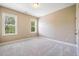 Well-lit bedroom featuring carpeted flooring, white trim, and two bright windows at 610 Bennett Mountain, Chapel Hill, NC 27516