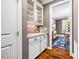 Butler pantry with granite countertop and glass cabinets, connecting to the dining area at 610 Bennett Mountain, Chapel Hill, NC 27516