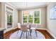 Bright dining area with a round table, stylish chairs, and large windows overlooking the outdoors at 610 Bennett Mountain, Chapel Hill, NC 27516