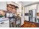 Modern kitchen features stainless steel appliances, brick backsplash and updated countertops at 610 Bennett Mountain, Chapel Hill, NC 27516