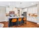 Contemporary kitchen with white cabinetry, granite countertops, stainless steel appliances and island with seating at 610 Bennett Mountain, Chapel Hill, NC 27516