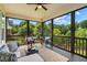 Inviting screened porch with comfortable seating and a view of lush green trees at 610 Bennett Mountain, Chapel Hill, NC 27516