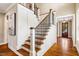 Beautiful staircase with wood treads, white risers, and iron railing at 610 Bennett Mountain, Chapel Hill, NC 27516