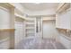 Spacious walk-in closet with ample shelving and carpeted floors at 610 Bennett Mountain, Chapel Hill, NC 27516