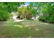 Expansive backyard with mature trees, a large lawn, and privacy fencing at 6412 Forest Ridge Dr, Durham, NC 27713