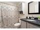 Updated bathroom with modern vanity, stylish shower curtain, and tiled flooring at 6412 Forest Ridge Dr, Durham, NC 27713