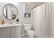 Clean bathroom with a single vanity, built in medicine cabinet, and a shower-tub combo at 6412 Forest Ridge Dr, Durham, NC 27713