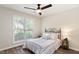 Bright bedroom features a ceiling fan and a large window providing natural light at 6412 Forest Ridge Dr, Durham, NC 27713
