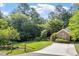 Inviting home with a well-kept lawn, mature trees, and a charming wooden fence at 6412 Forest Ridge Dr, Durham, NC 27713