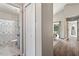 Well-lit hallway with hardwood floors, leading to a bathroom and living area at 6412 Forest Ridge Dr, Durham, NC 27713