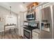 Well-lit kitchen with stainless steel appliances, granite countertops, and a decorative backsplash at 6412 Forest Ridge Dr, Durham, NC 27713
