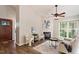 Cozy living room with fireplace, two chairs, and a large window offering natural light at 6412 Forest Ridge Dr, Durham, NC 27713