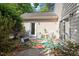 Charming outdoor patio area with seating, a colorful rug, and mature landscaping at 6412 Forest Ridge Dr, Durham, NC 27713