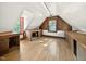 Bright and airy attic featuring wood floors, built-in shelving, and natural light from multiple windows at 6728 Glen Forrest Dr, Chapel Hill, NC 27517