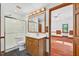 Bathroom features a wooden vanity, a shower, a toilet, and a doorway to the bedroom at 6728 Glen Forrest Dr, Chapel Hill, NC 27517