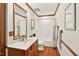Bathroom features wooden trim, vanity with sink, and shower/tub combination, blending style and function at 6728 Glen Forrest Dr, Chapel Hill, NC 27517