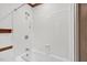Clean white tiled shower and tub combination features a wooden trim accent at 6728 Glen Forrest Dr, Chapel Hill, NC 27517
