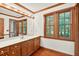 Bright bathroom with vanity, large mirror, and two windows for natural light at 6728 Glen Forrest Dr, Chapel Hill, NC 27517