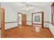 Spacious bedroom featuring hardwood floors, trim work, and doors leading to other rooms at 6728 Glen Forrest Dr, Chapel Hill, NC 27517