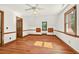 Bright, spacious bedroom showcasing hardwood floors, window views, and neutral wall paint at 6728 Glen Forrest Dr, Chapel Hill, NC 27517