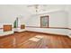 Spacious bedroom with hardwood floors, a ceiling fan, and natural light from the window at 6728 Glen Forrest Dr, Chapel Hill, NC 27517