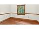 Bright bedroom features a window offering natural light and hardwood flooring at 6728 Glen Forrest Dr, Chapel Hill, NC 27517