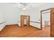 Bright bedroom features hardwood floors, a ceiling fan, and closet and hallway access at 6728 Glen Forrest Dr, Chapel Hill, NC 27517