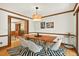 Dining room features a modern light fixture, wood floors, and view to living room at 6728 Glen Forrest Dr, Chapel Hill, NC 27517