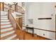 Bright foyer with a wooden staircase, hardwood floors, and stylish accents at 6728 Glen Forrest Dr, Chapel Hill, NC 27517