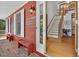 Entrance to a red home showing the foyer with hardwood floors and stairs at 6728 Glen Forrest Dr, Chapel Hill, NC 27517