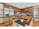 Bright kitchen features a breakfast bar island, stainless steel appliances and tile backsplash at 6728 Glen Forrest Dr, Chapel Hill, NC 27517