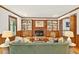 Comfortable living room with hardwood floors, a fireplace, built-in bookshelves, and ample seating at 6728 Glen Forrest Dr, Chapel Hill, NC 27517