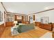 Cozy living room featuring hardwood floors, built-in bookshelves, and a comfortable green sofa at 6728 Glen Forrest Dr, Chapel Hill, NC 27517