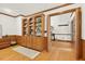 Spacious office featuring built-in wooden shelving and hardwood floors at 6728 Glen Forrest Dr, Chapel Hill, NC 27517
