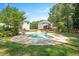 The backyard features a pristine pool area with a manicured lawn and mature trees enhancing privacy at 8512 Barrett Hall Ln, Wake Forest, NC 27587