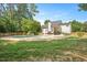 The backyard features a serene pool area surrounded by well-maintained grass and mature trees at 8512 Barrett Hall Ln, Wake Forest, NC 27587