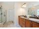 Modern bathroom featuring double vanity, granite countertops, large glass shower and tile floors at 8512 Barrett Hall Ln, Wake Forest, NC 27587