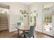 Bright breakfast nook with large windows, hardwood floors and modern lighting fixture at 8512 Barrett Hall Ln, Wake Forest, NC 27587