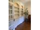 Elegant built-in shelving with classic white cabinetry and hardwood floors at 8512 Barrett Hall Ln, Wake Forest, NC 27587
