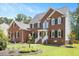 Beautiful brick house with well-manicured lawn, and white stair railing at 8512 Barrett Hall Ln, Wake Forest, NC 27587