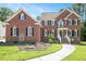 Charming brick home featuring manicured lawn and inviting front entrance at 8512 Barrett Hall Ln, Wake Forest, NC 27587
