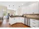 Bright kitchen with stainless steel appliances, white cabinets, and hardwood floors at 8512 Barrett Hall Ln, Wake Forest, NC 27587