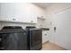 Well-equipped laundry room with modern washer and dryer, ample storage and tile floors at 8512 Barrett Hall Ln, Wake Forest, NC 27587