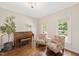Cozy living room with hardwood floors and large windows at 8512 Barrett Hall Ln, Wake Forest, NC 27587