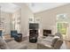 Inviting living room featuring a fireplace, neutral colors, large windows and lots of natural light at 8512 Barrett Hall Ln, Wake Forest, NC 27587