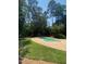 Backyard pool featuring a concrete patio surround and mature trees at 8512 Barrett Hall Ln, Wake Forest, NC 27587