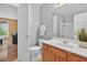 Half bath featuring a wood vanity, toilet, shower, and a view into an adjacent living area at 9 Monteith Ct, Durham, NC 27713
