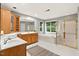 Bright bathroom with a double vanity, soaking tub, and glass enclosed shower stall at 9 Monteith Ct, Durham, NC 27713